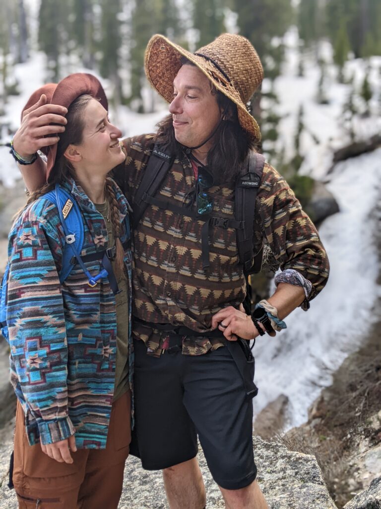 couple posed in front of a waterfall