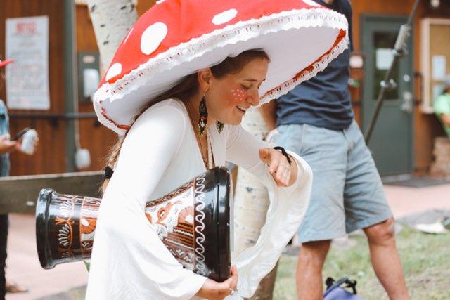 girl drumming in mushroom costume