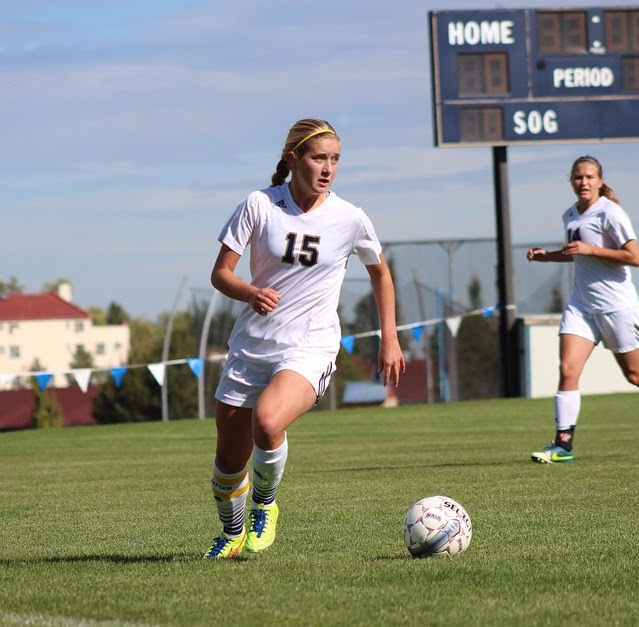 soccer player running with ball