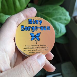 skincare salve with blue lettering and an orange background