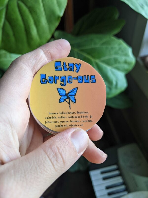 skincare salve with blue lettering and an orange background